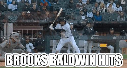 a baseball player named brooks baldwin hits a ball in front of a crowd