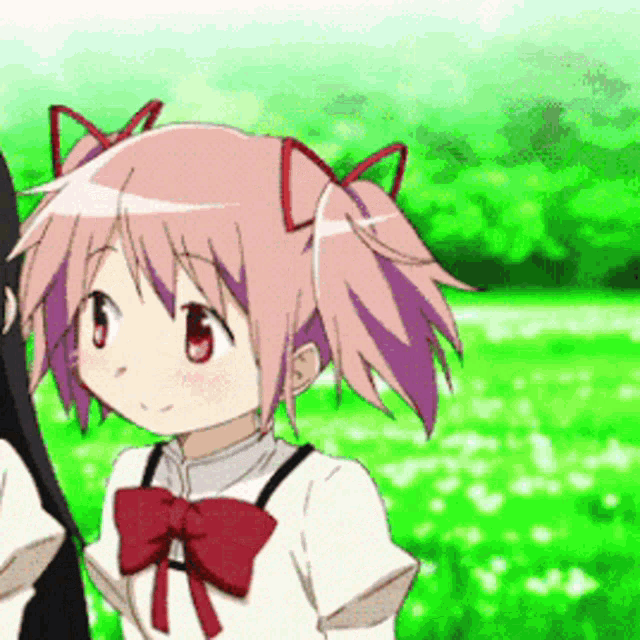 a girl with pink hair and a red bow is standing in a field .
