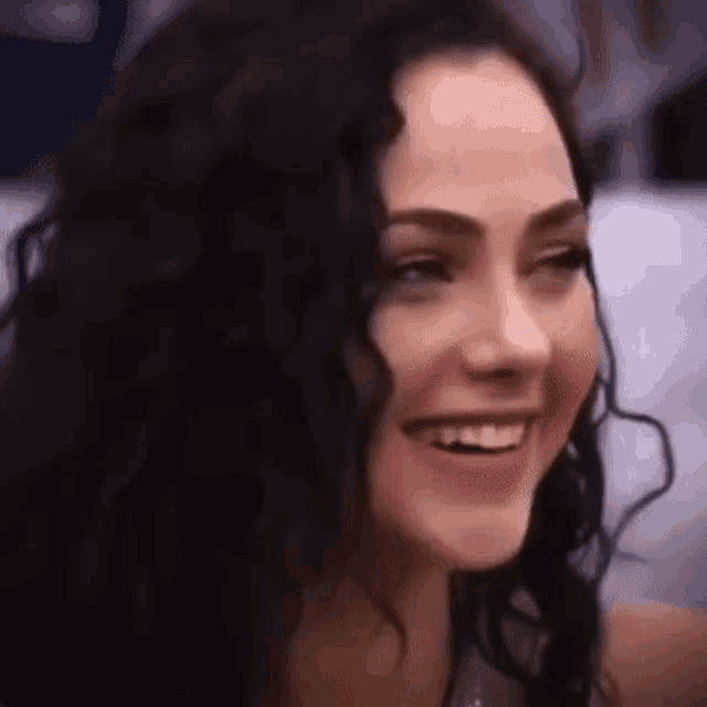 a close up of a woman 's face smiling .