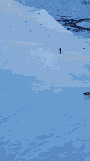 a person is skiing down a snowy hill