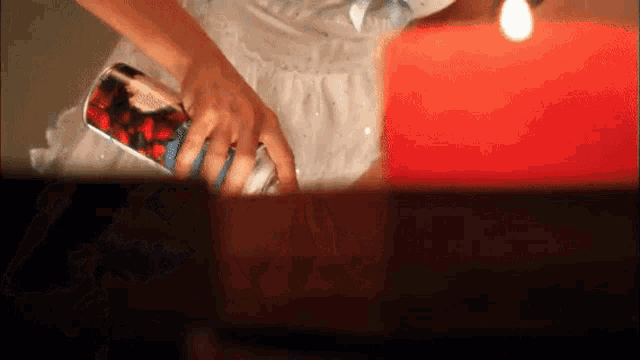 a woman in a white dress is holding a bottle with a picture of strawberries on it