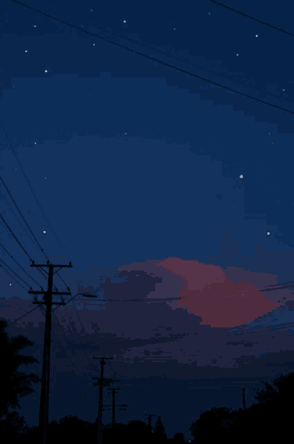 a shooting star is visible in the night sky above a telephone pole