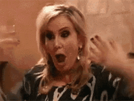 a woman is making a funny face with her mouth open .