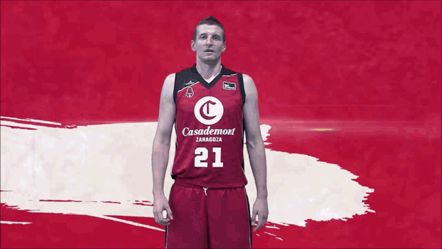 a basketball player wearing a casademon jersey number 21