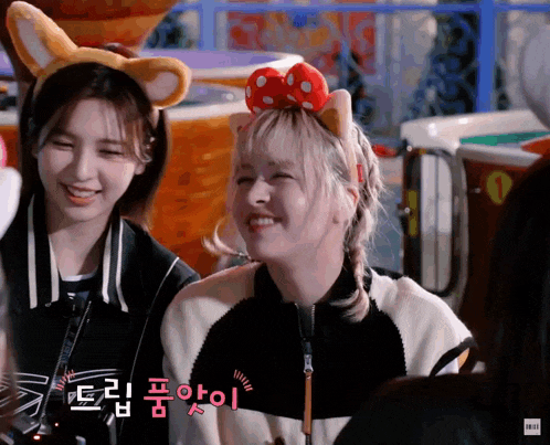 two girls wearing bunny ears and a bow on their head