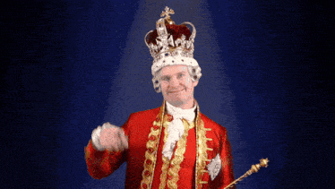 a man dressed as a king with a crown and scepter
