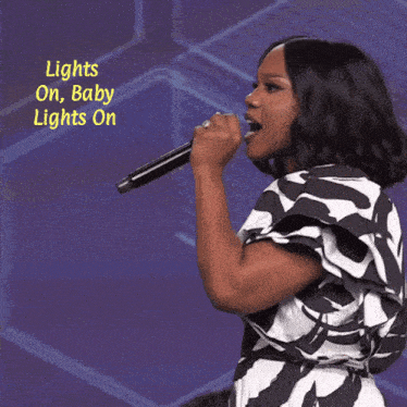 a woman singing into a microphone with the words lights on baby lights on
