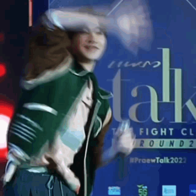 a man is standing in front of a sign that says talk on it .