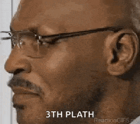 a bald man wearing glasses and a mustache is making a funny face .