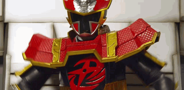 a red and black superhero with a chinese symbol on his chest