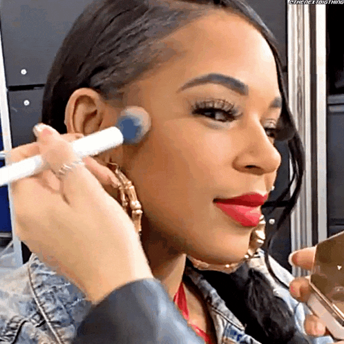 a woman is getting her makeup applied by someone with the hashtag #thenextbig thing