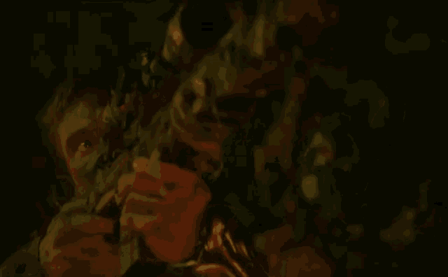 a man is being attacked by a group of zombies in a dark room in a blurry photo .
