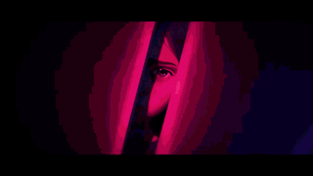 a woman 's face is peeking out from behind a door
