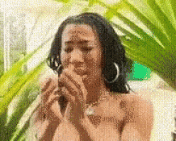a pixelated image of a naked woman covering her mouth with her hands