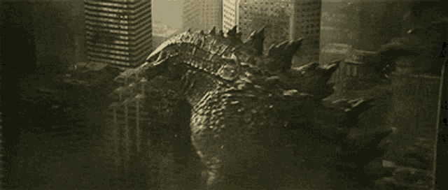 a black and white photo of a monster in a city with buildings in the background