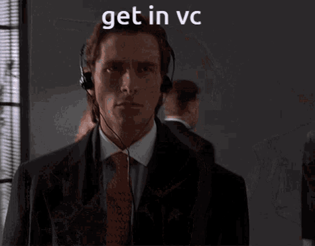 a man in a suit and tie is wearing headphones and the words get in vc are above him