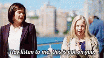 two women are standing next to each other and one of them says hey listen to me this is not on you