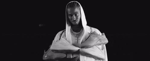 a black and white photo of a man in a hooded jacket