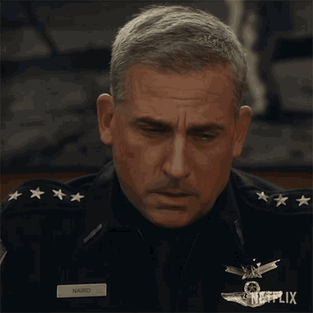a man in a military uniform has a name tag that reads naird
