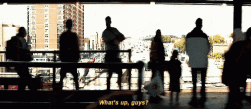 a group of people standing on a bridge with the words what 's up guys