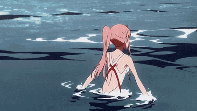 a girl with pink hair is swimming in the water