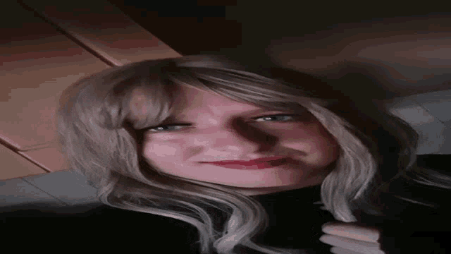 a close up of a woman 's face with blonde hair