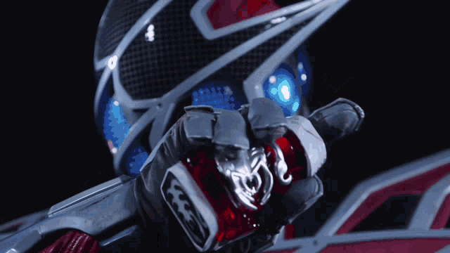 a close up of a person wearing a helmet and holding a red item