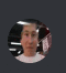 a blurry picture of a man 's face in a circle on a gray background .