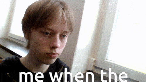 a young man sitting in front of a window with the words " me when the " written on the bottom