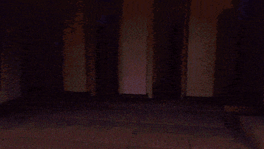 a dark room with purple walls and a purple floor