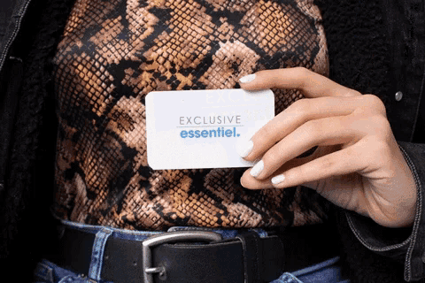 a person holding a card that says exclusive essentiel