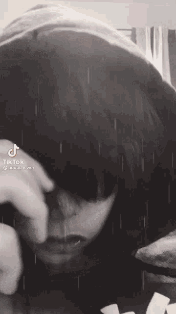 a black and white photo of a person with tiktok written on the bottom left