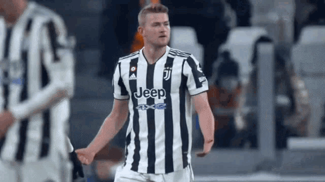 a soccer player wearing a jeep jersey is celebrating a goal