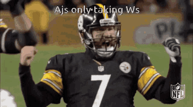 a football player with the number 7 on his jersey is raising his arms in the air