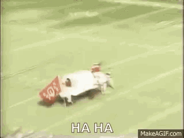a group of baseball players are playing a game of baseball and one of them is wearing a helmet .