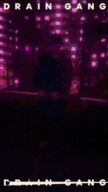 a poster for drain gang shows a person standing in a dark park