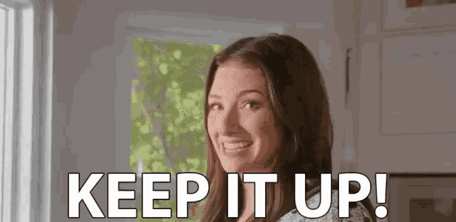a woman is smiling and saying `` keep it up ! ''