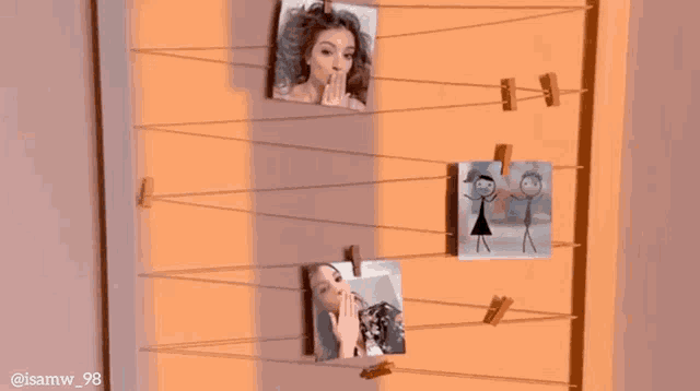 a picture of a woman and a drawing of a boy are hanging on a string