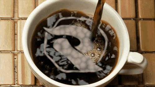 a cup of coffee with the letter r on the bottom