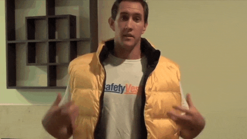 a man wearing a vest that says safety vest