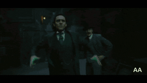a man in a suit is surrounded by green glowing lights .