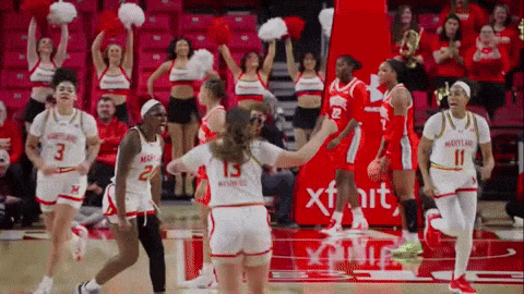 a basketball game is being played in front of an xfinity banner
