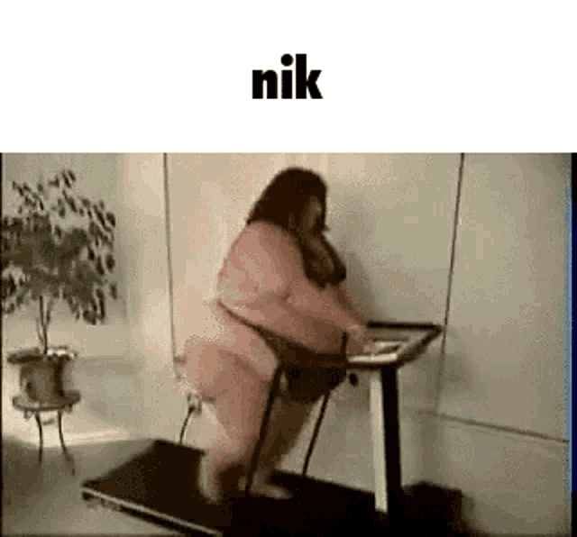 a very fat woman is walking on a treadmill in a room .