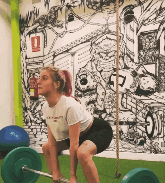 a woman squatting with a t-shirt that says authentic me on it