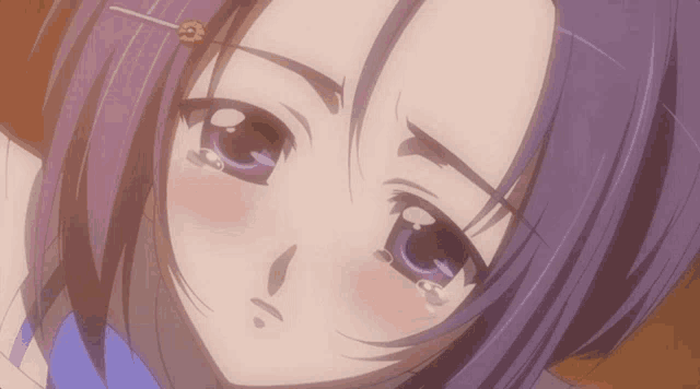 a close up of a girl with purple hair making a face