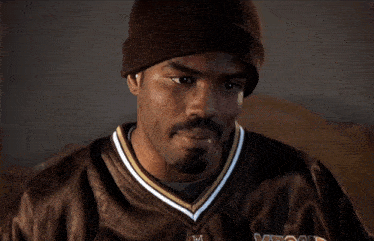 a man wearing a brown jersey with the word detroit on the front