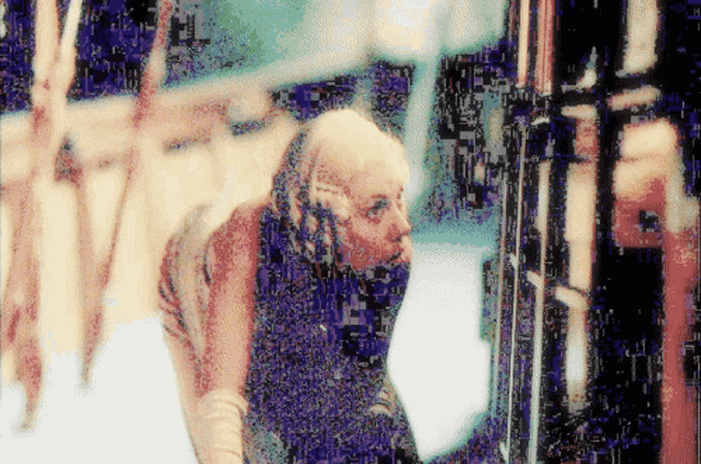 a pixelated image of a woman with a beard and a scarf around her neck