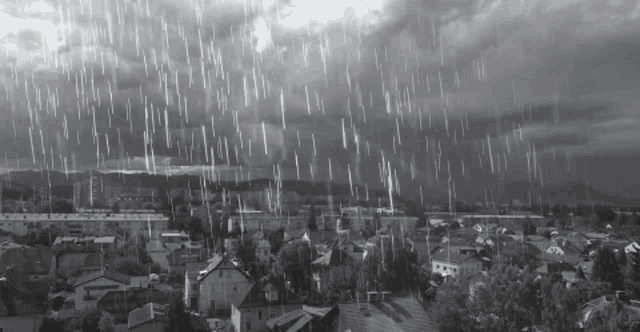 a black and white photo of a city during a rain storm