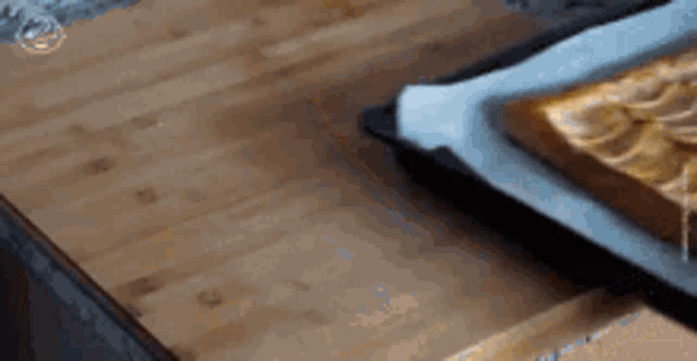 a piece of banana cake is sitting on a wooden table .