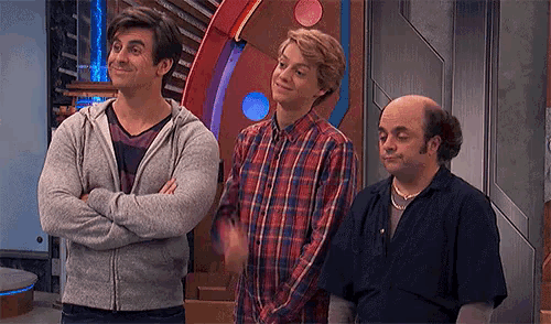 three men are standing next to each other with their arms crossed and one has a bald head
